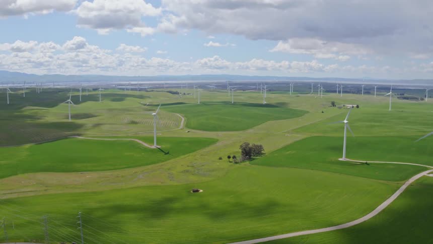 The fields are empty besides windmills