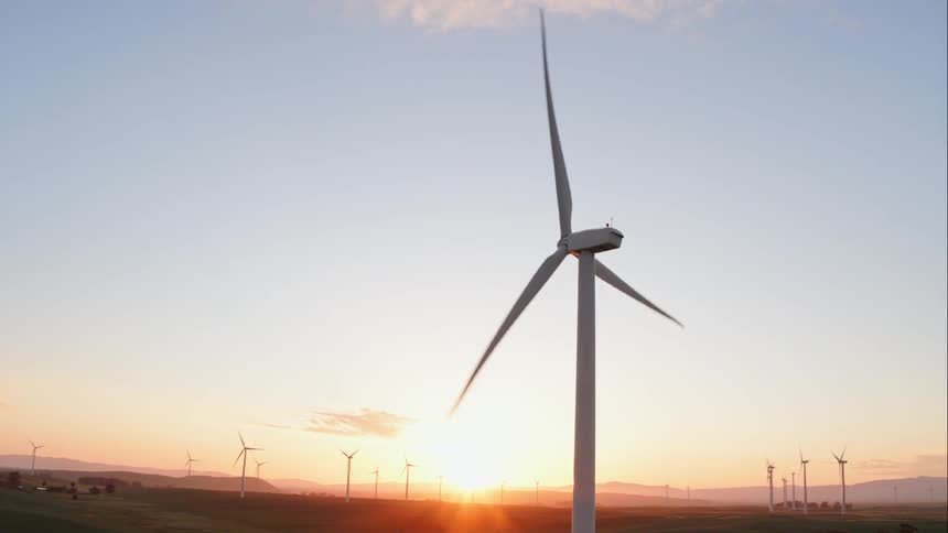 The windmills turn at sunset