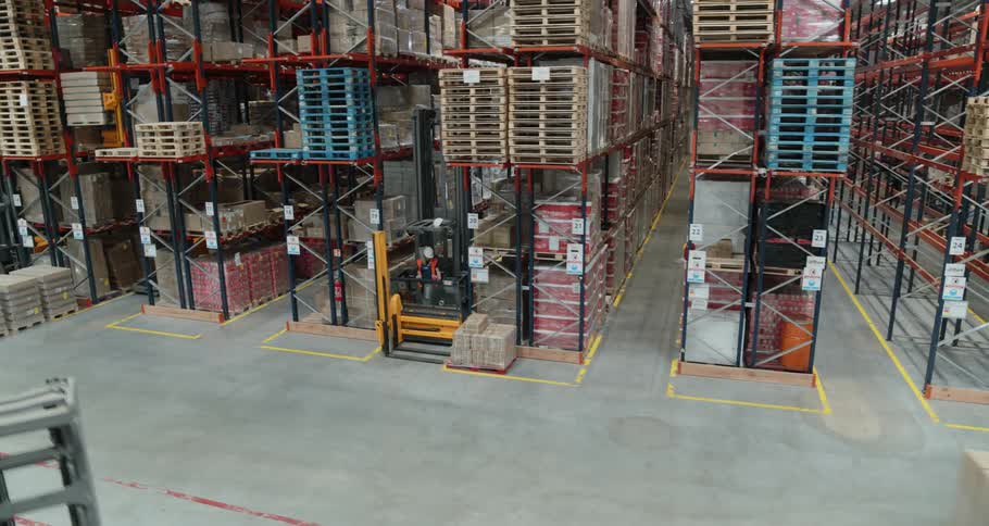Men in a warehouse operating forklifts