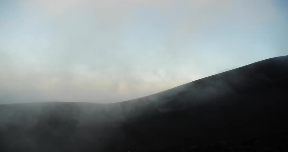 Mist rolling down hills covered in shadow
