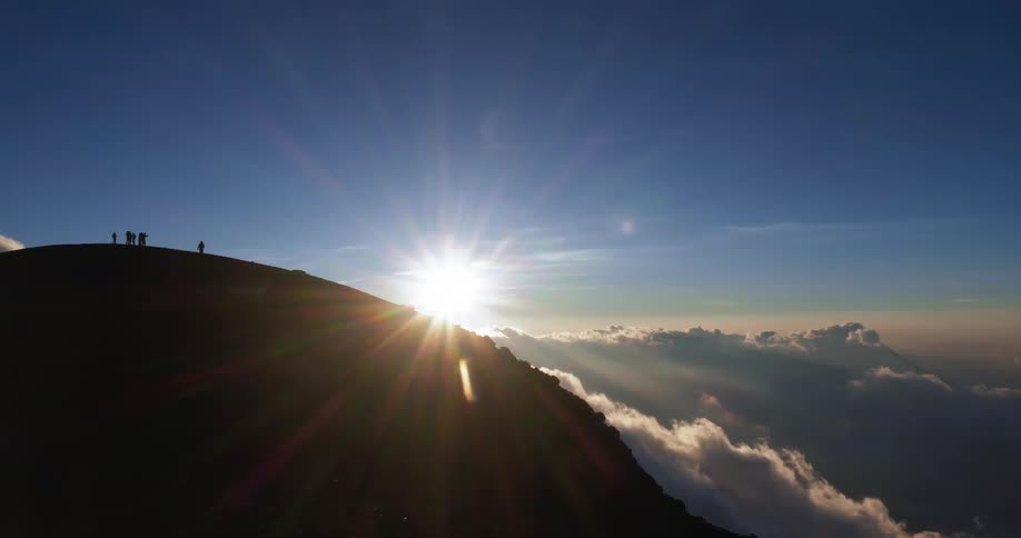 A scenery at the mountain peak above the cloud with a sun flare