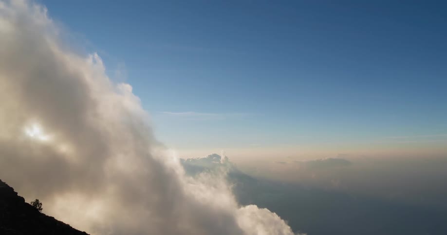 A footage of a cloud moving near the mountain apex