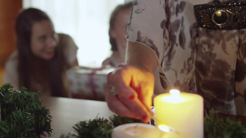 A woman lights a candle