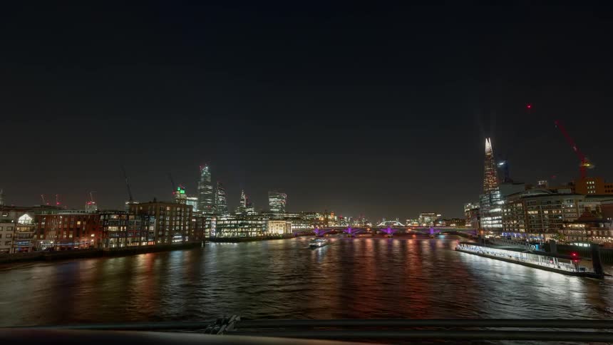 Time lapse of boats on the river thames at night