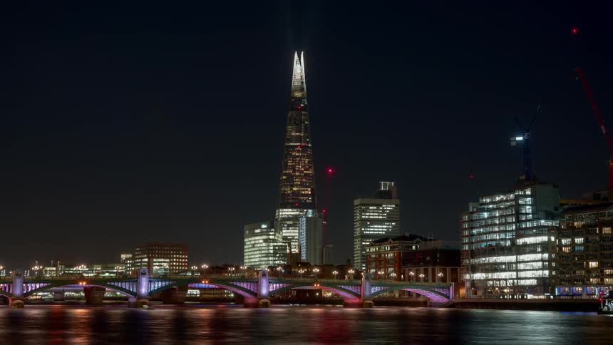 Time lapse of boats on the river thames at night