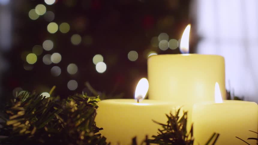 Three candle flames wave around