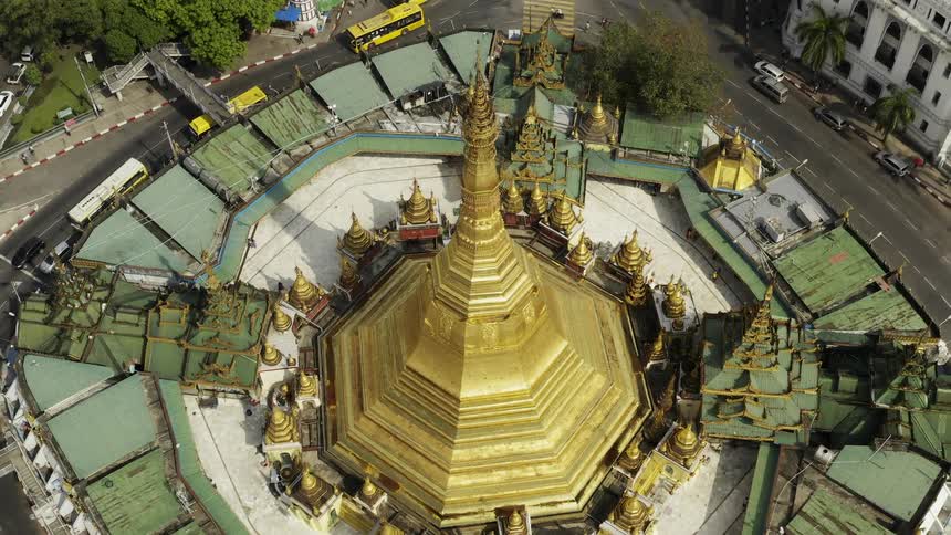 A roundabout with buildings and trees in the background