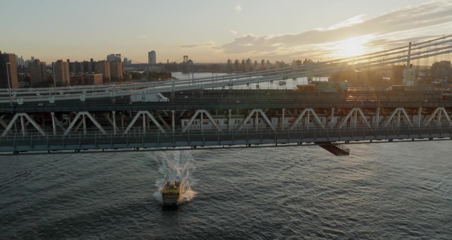 A boat moves across a river under a bridge