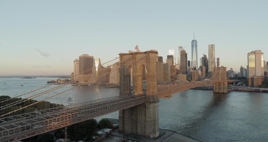 Vehicles travel a large bridge to a big city