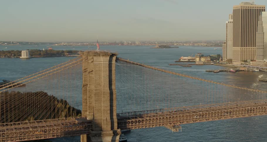 A bridge with cars on it hangs over a large river
