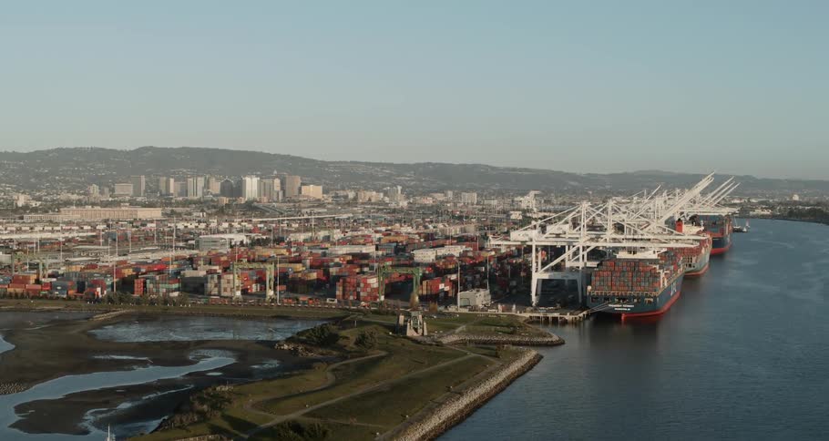 A shipping dock with cranes and shipping containers