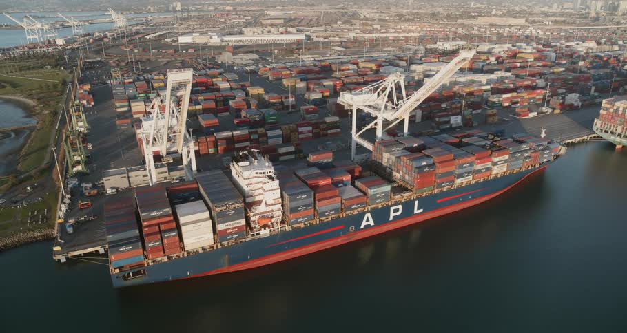 A shipping container at port with large cranes