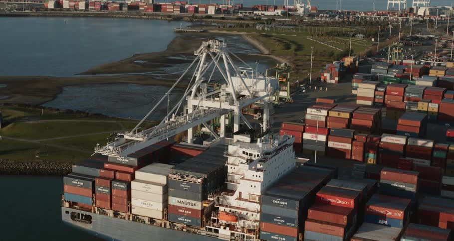 A shipping port with a shipping tanker and shipping containers