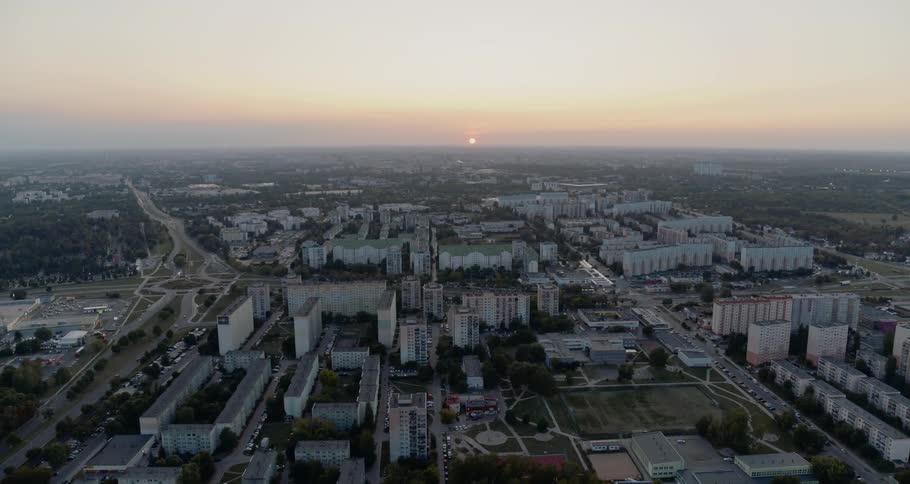 Apartments and other buildings surrounded by parks and highway