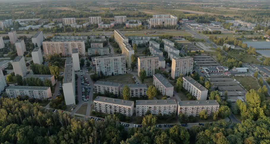 A large apartment building complex with trees surrounding
