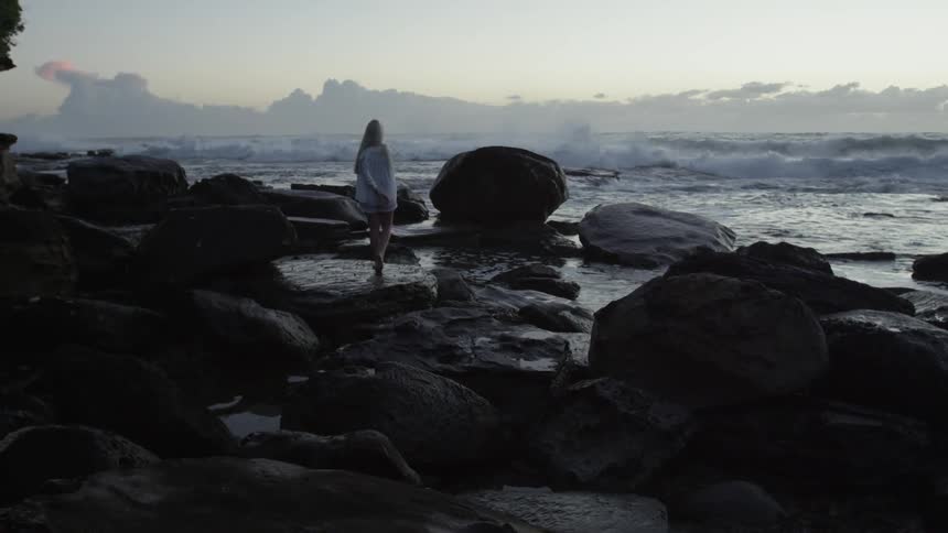 Girl Walking Along Beach