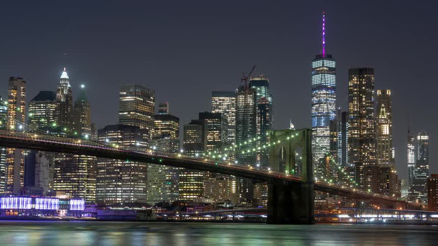 A downtown skyline is lit up as dusk turns to night