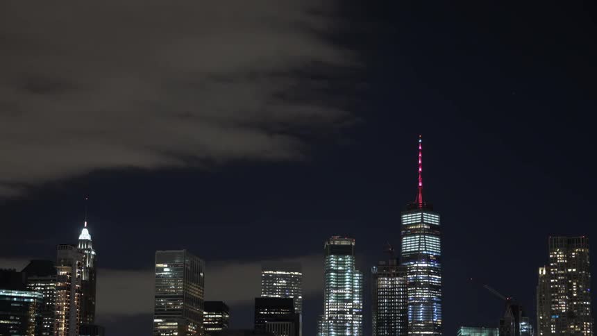 Clouds move over the city at night