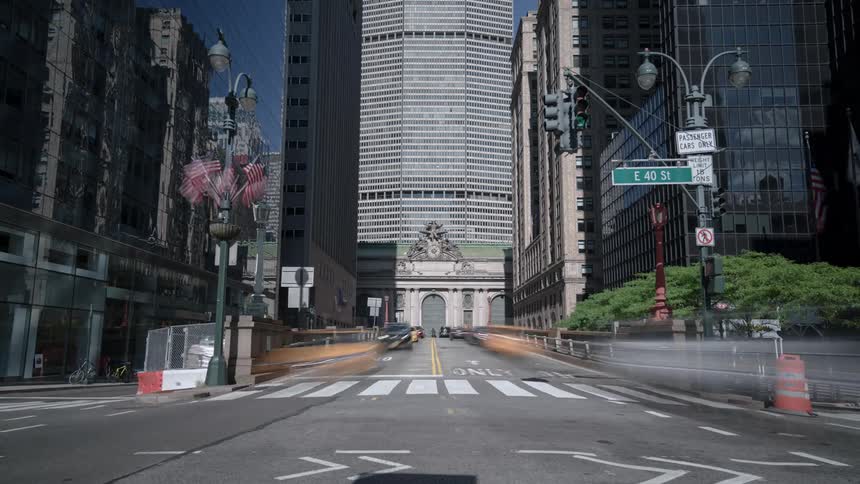 Vehicles and bicyclists travel on the city street