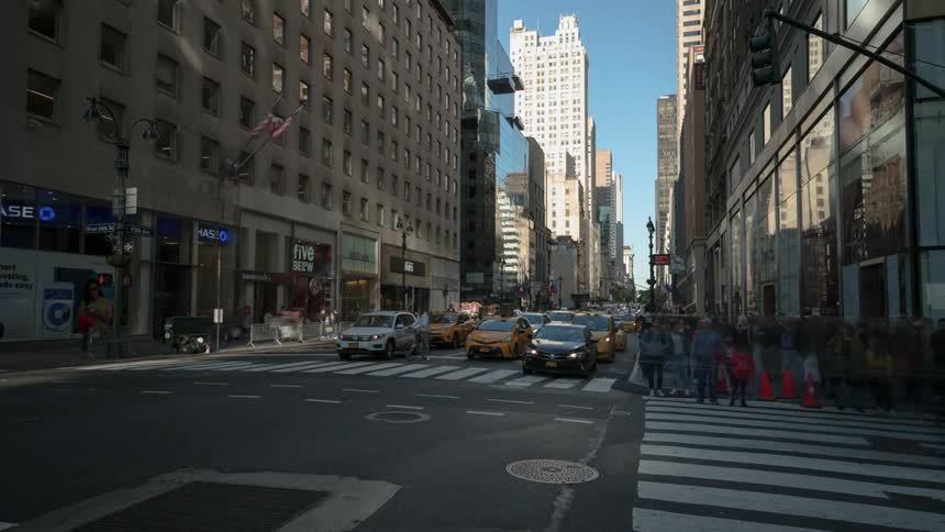 A busy intersection in a metropolis during the day