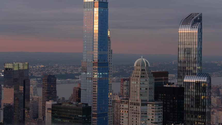 Skyscrapers in a city sit under a cloudy sky