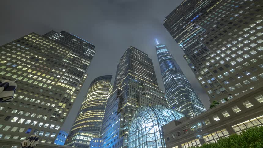 Clouds stream over a city at night