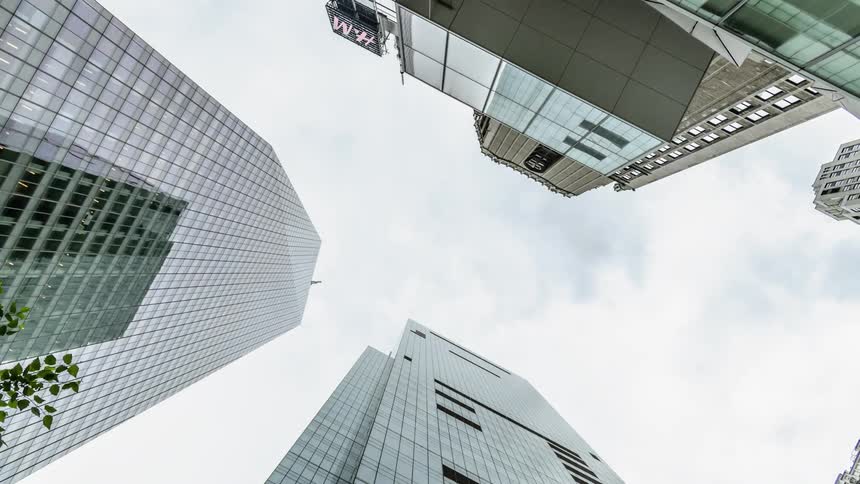White clouds move over the tall buildings