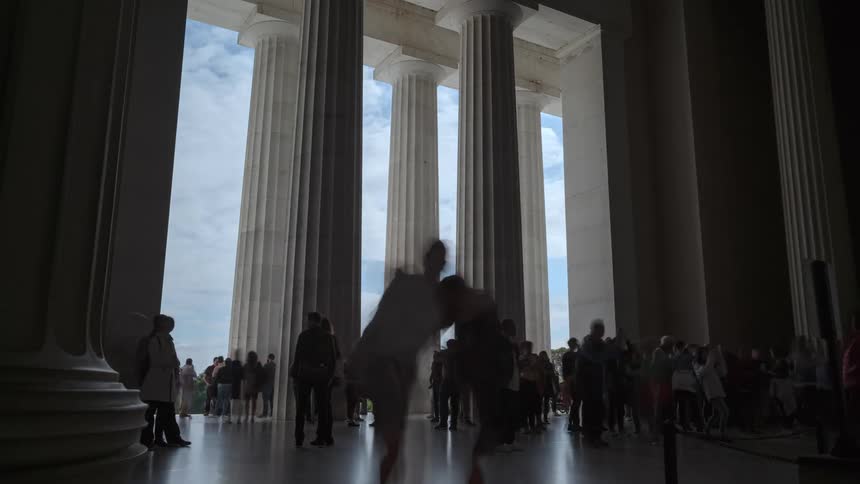Tourists visit a monument and stop to take pictures