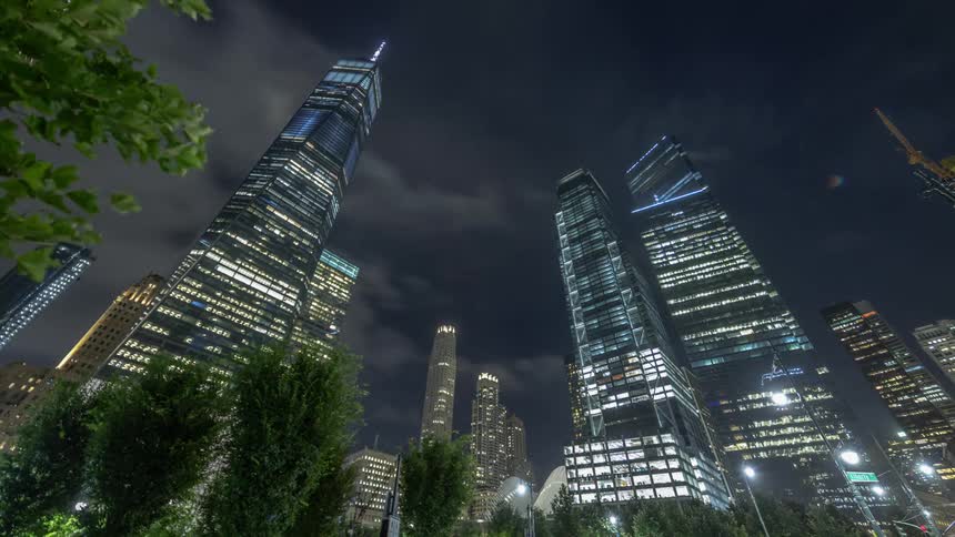 Lights inside high rise buildings brighten up a city sky at night