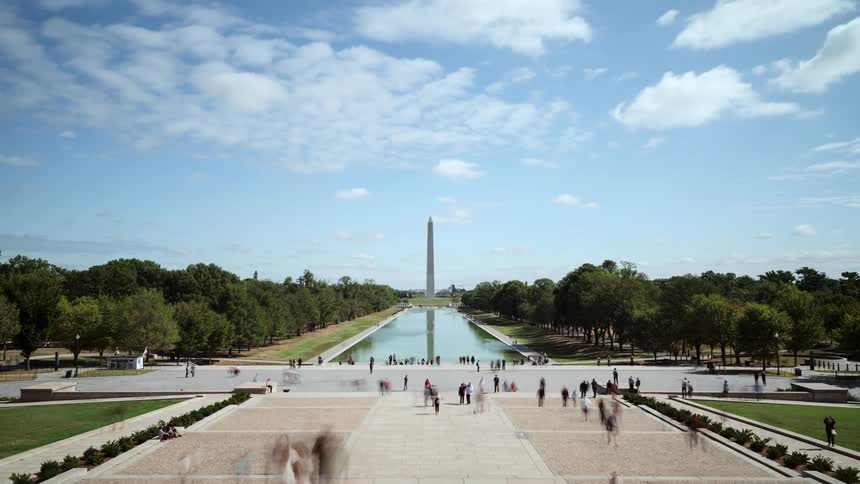 Tourists walk through plaza near washington monument