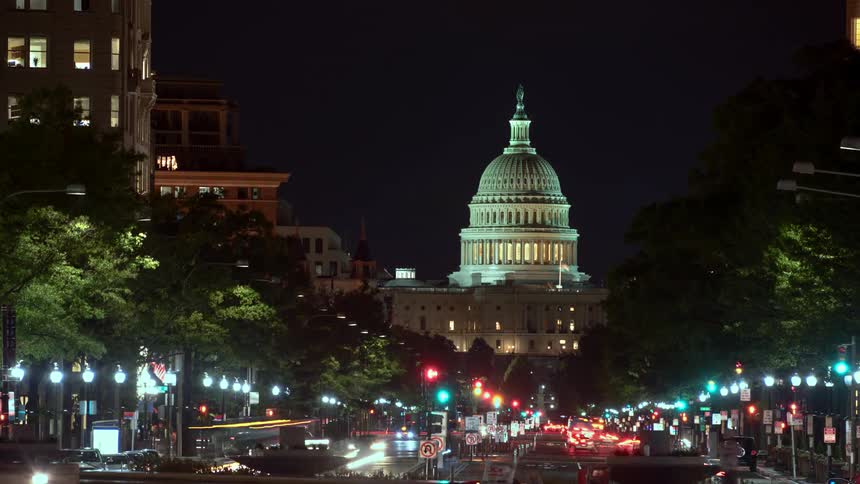 Traffic moves through washington dc at night