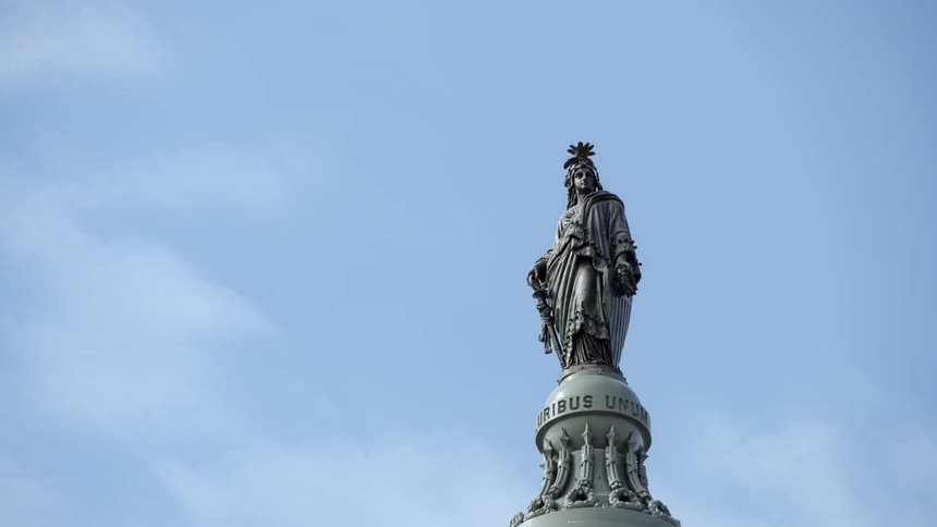 Clouds move over a statue