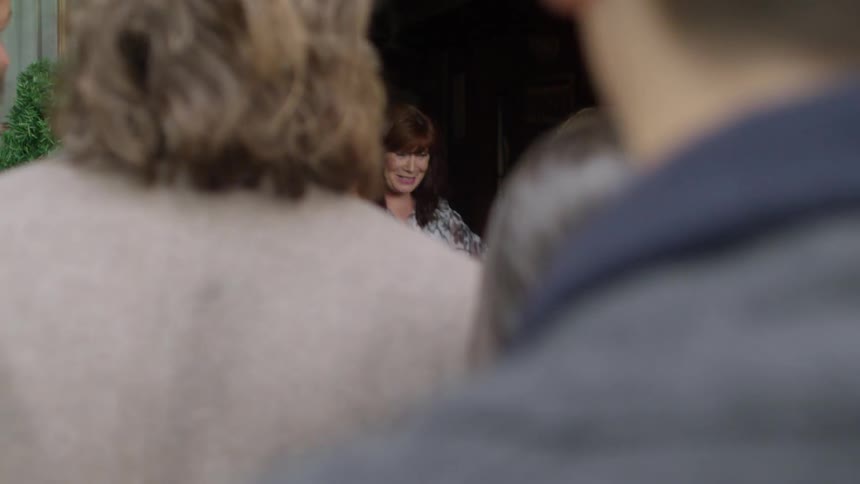A group of people walking into a house