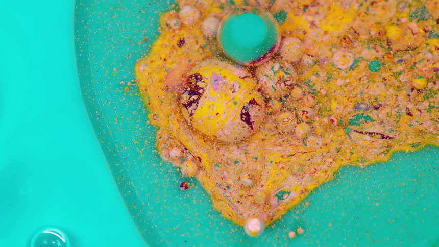 Liquids and paint of varying viscosity form art that looks like speckled eggs