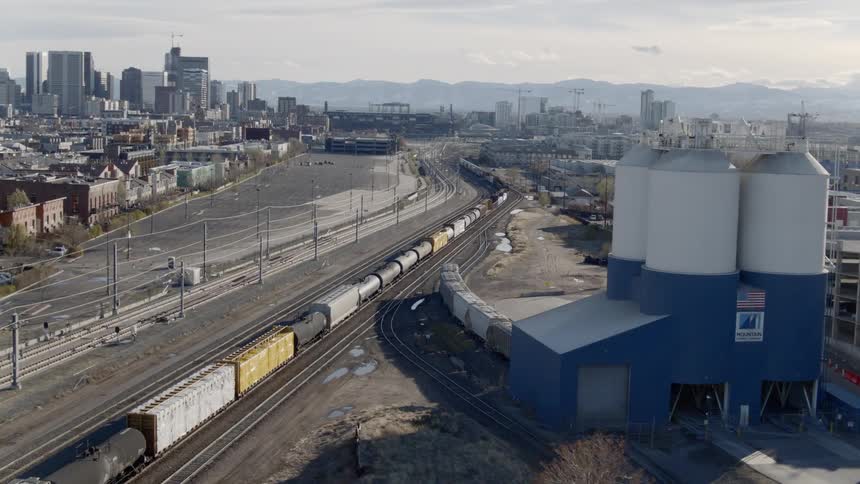 Trains stopped on tracks on the outskirts of a city