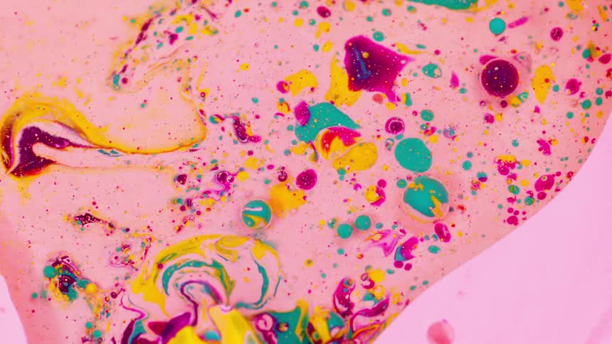 An assortment of colors on a pink liquid