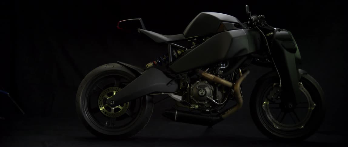 A futuristic motorcycle sits in a showroom