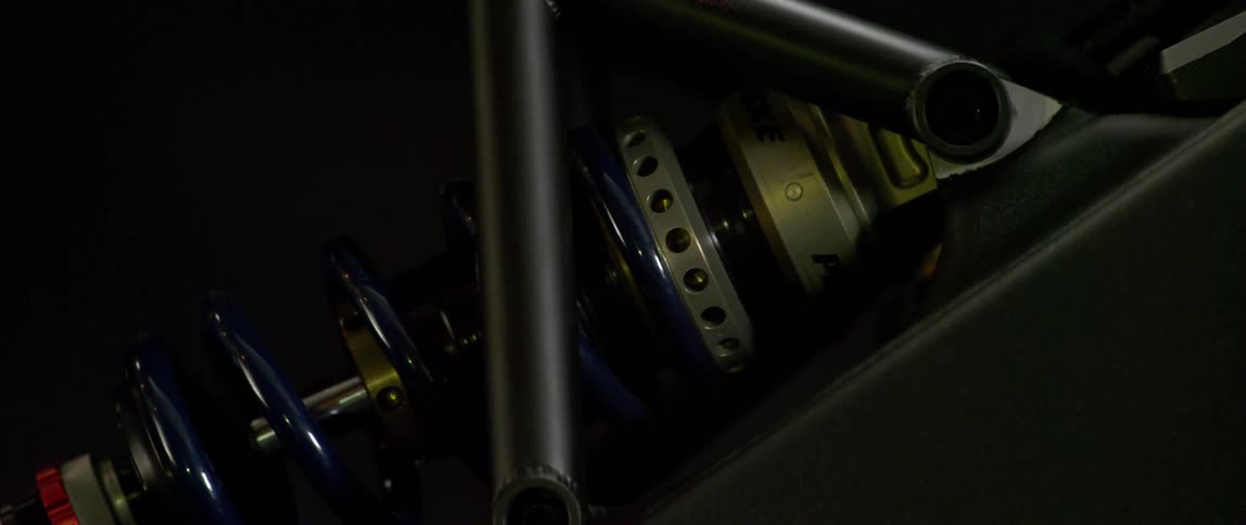 The machine is in a dark room with a spiral tube around it
