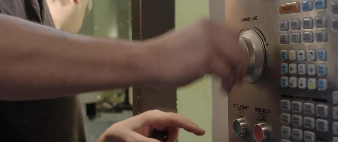 A man turning a dial on a device