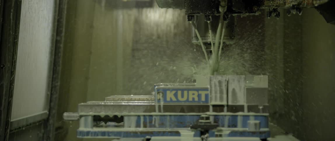 A drilling device cuts through material and sends debris flying