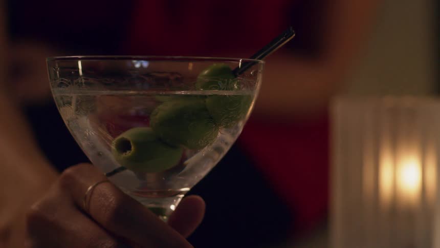 A person lifting a cocktail class