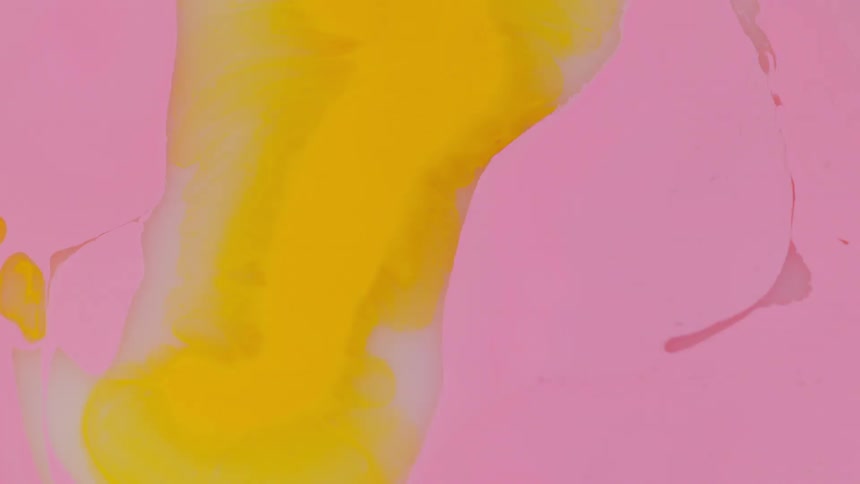 A drop of fluid falls into a liquid