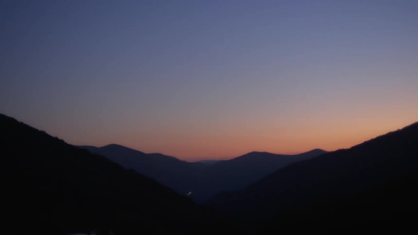 A valley between two mountains in the evening