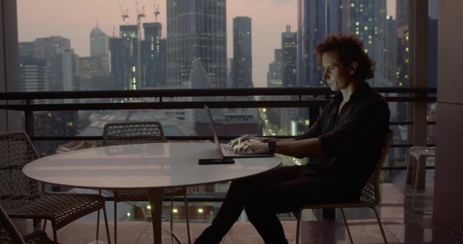 A man sits at his computer