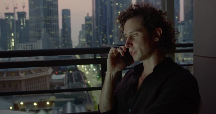A person talking on the phone in a highrise