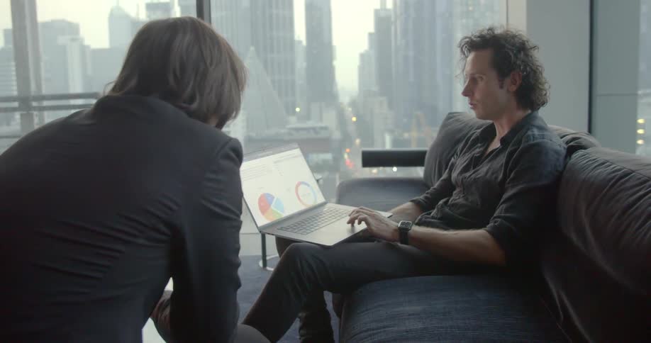 Two people talk together in an office