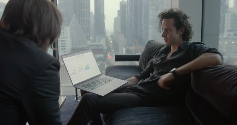 Two coworkers are talking in an office