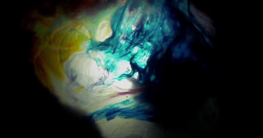 Blue and yellow liquid swirls together to form patterns