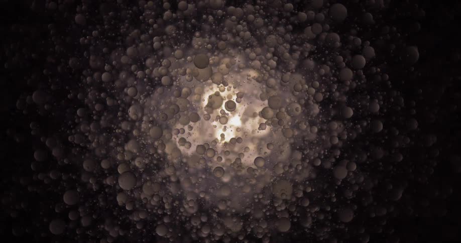 Clear blobs appear to fall against a back light