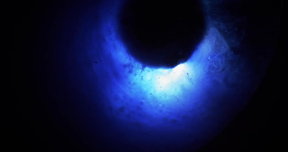 The blue water circles the black sphere